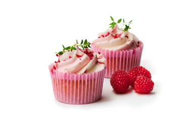 Сupcakes  with fresh raspberries and cream isolated on white
