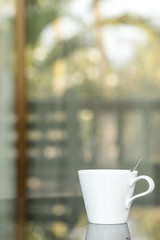 Close up A cup of coffee with outdoor background