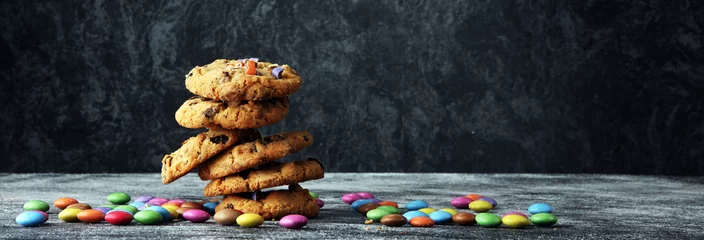 Rolgordijnen Chocolate cookies with colorful candies. Chocolate chip smarties cookies. © beats_