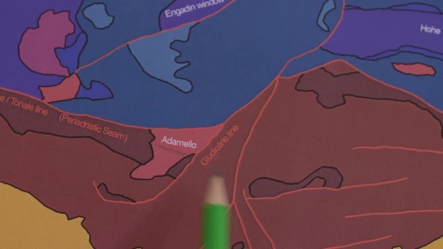 close up on Hand of business man marks place with a pencil on a map