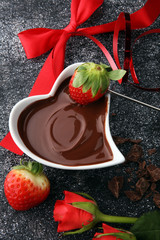 Valentine Chocolate fondue melted with fresh strawberries and dark chocolate and roses