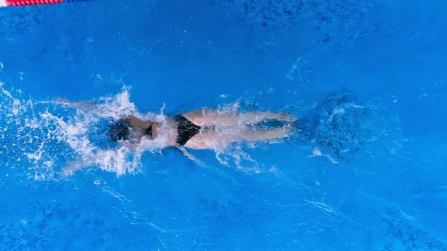 A perfect butterfly by a female swimmer shown from above. 