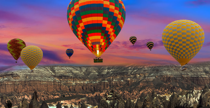 Colorful hot air balloons flying over landscape at Cappadocia Turkey