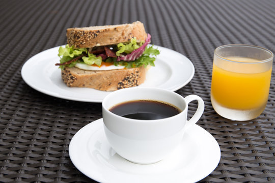 Cup of coffee with egga sandwich and orange juice