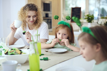 Family eating tasty cookies at the table