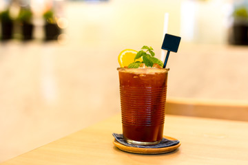 Iced tea with lemon and mint on the table