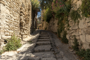 Steep alley with medieval houses in Gordes. Provence, France