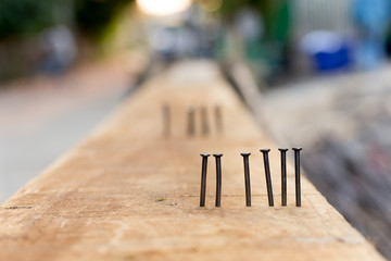 Nails on ths wood in construction site