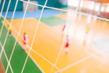 Football defocused players on field, Futsal ball field in the gym indoor, Soccer sport field