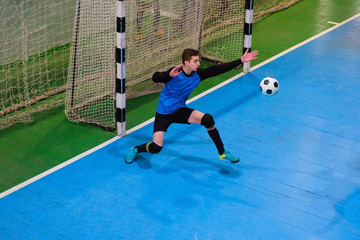 Football goalkeeper on goal, field, Futsal ball field in the gym indoor, Soccer sport field