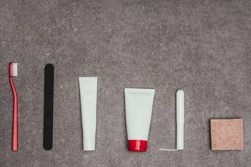 top view of arrangement of feminine hygiene supplies on grey surface