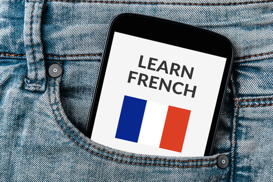 Learn French concept on smartphone screen in jeans pocket. All screen content is designed by me. Flat lay