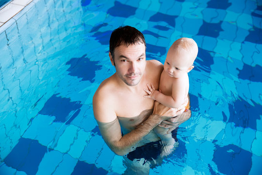Smiling charming baby in swimming pool