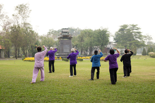 Elderly people doing tai chi exercises