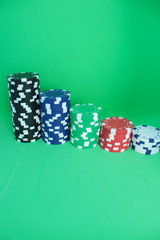 Poker chips on green background.