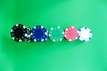 Poker chips on green background.