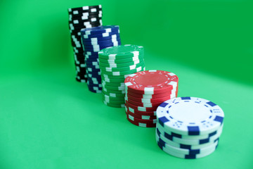 Poker chips on green background.