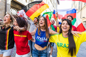 Happy fans supporters from different countries walking and chanting together