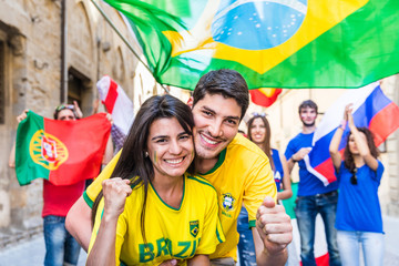 Happy Brazilian couple supporters celebrating victory