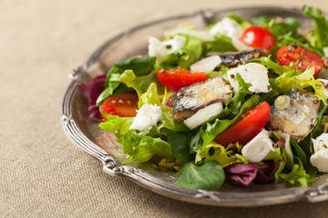 A delicious salad with sardines and feta cheese.