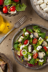 A delicious salad with sardines and feta cheese.