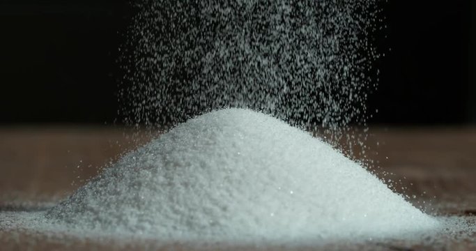 Falling sugar cane granules shot on high speed camera, phantom flex