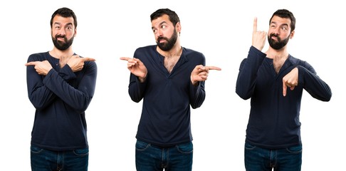 Set of Handsome man with beard pointing to the laterals having doubts