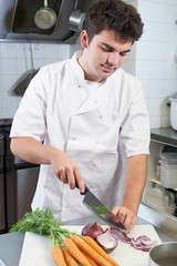 Chef Preparing Vegetables In Restaurant Kitchen