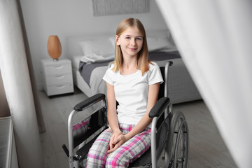 Teenage girl in wheelchair indoors