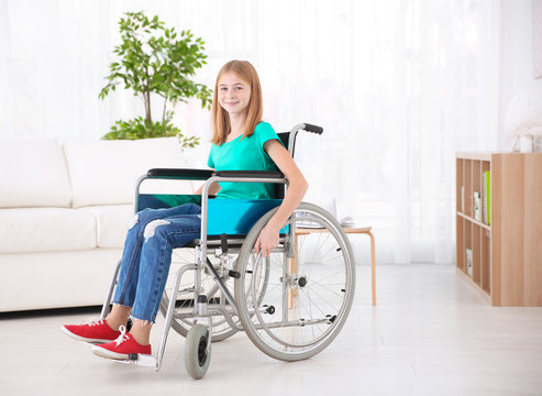 Teenage girl in wheelchair indoors