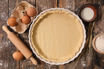 raw dough with rolling pin,egg and flour