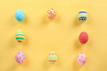 Decorated Easter eggs on color background