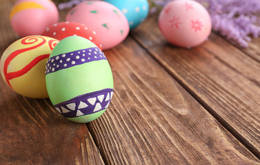 Decorated Easter eggs on wooden background