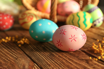Decorated Easter eggs on wooden table, closeup