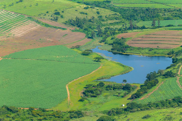 Fototapeta na wymiar Flying Farmlands Fields Crops Dam Landscape