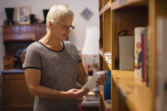 Senior woman selecting a book
