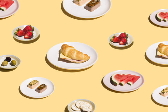 Variety of lunch served on plates isolated against yellow background