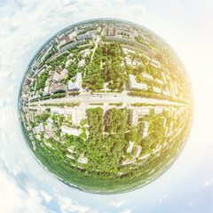 Aerial city view with crossroads and roads, houses, buildings, parks and parking lots, bridges. Helicopter drone shot. Wide Panoramic image.