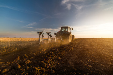Tractor plowing fields -preparing land for sowing in autumn