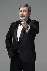 Senior Businessman standing and pointing to camera