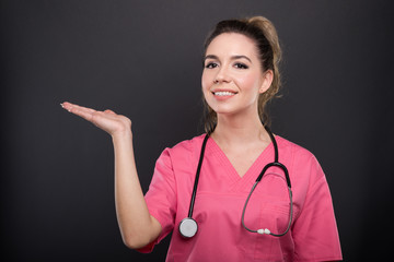 Portrait of attractive lady doctor holding copypsace area