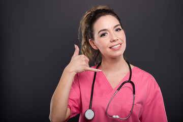 Portrait of lady doctor showing contact or calling gesture