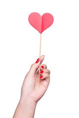 Woman's hand holding red heart isolated on white.