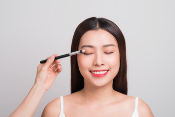 Fototapeta premium Beautiful asian woman face with perfect makeup applying blusher.