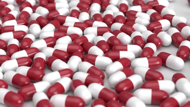 Rot wei&szlig;e Tabletten - Pillen fallen auf den Boden