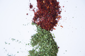 Dry herbs and crushed red pepper isolated on white background with copy space