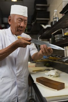 Senior chef holding knife in the kitchen