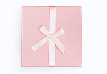 Pink gift box with ribbon and bow isolated on white background. Top view
