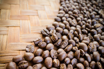 Organic roaster coffee beans on bamboo threshing basket.