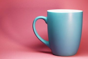 Blue tea cup on pink background food photo